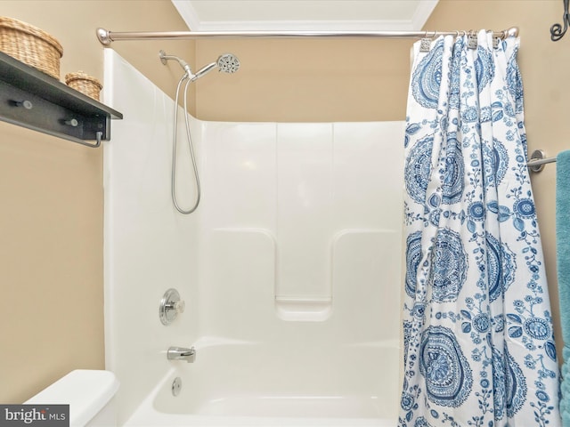 bathroom with ornamental molding, toilet, and shower / bath combo