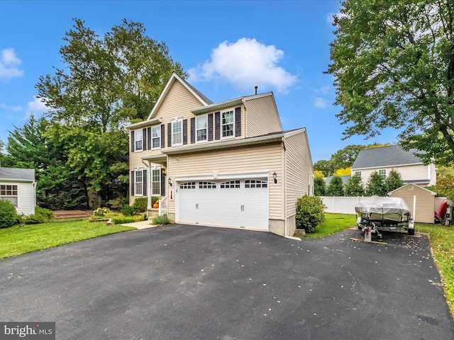 view of front of house with a garage and a front yard