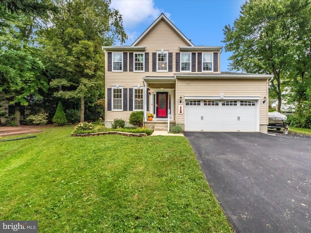 colonial-style house with a garage and a front yard