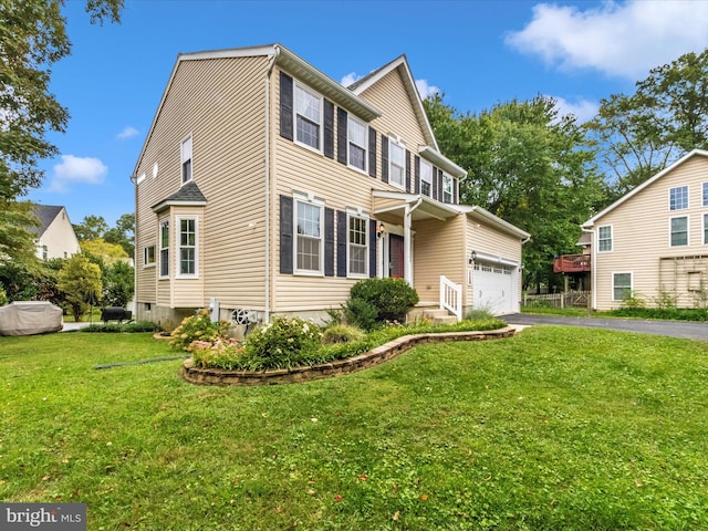 view of front facade with a front yard and a garage