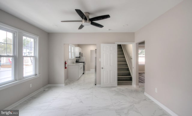 interior space with ceiling fan