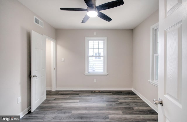 empty room featuring dark wood-type flooring and ceiling fan