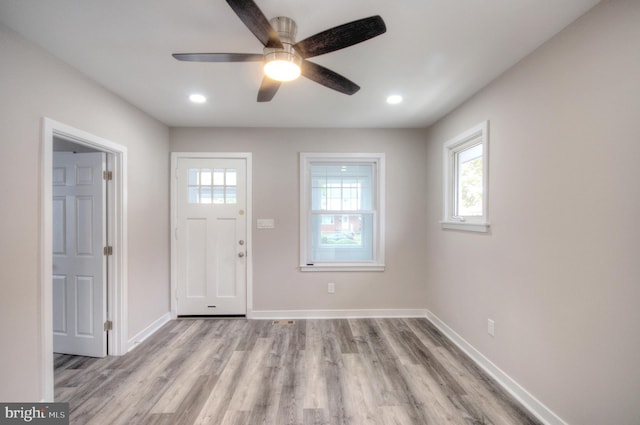 foyer with ceiling fan and light hardwood / wood-style flooring