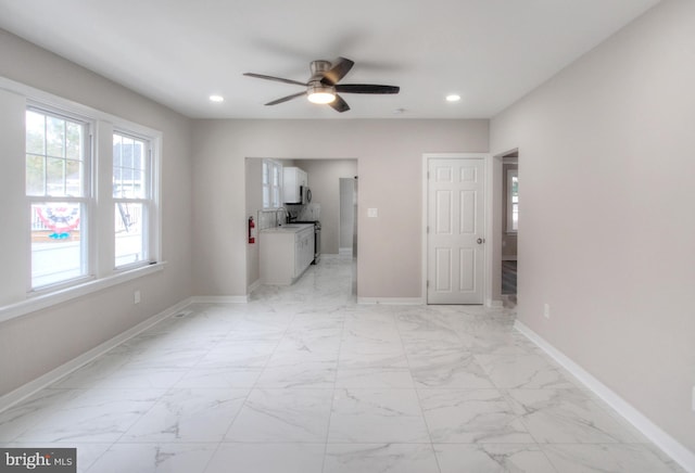 spare room with ceiling fan and sink