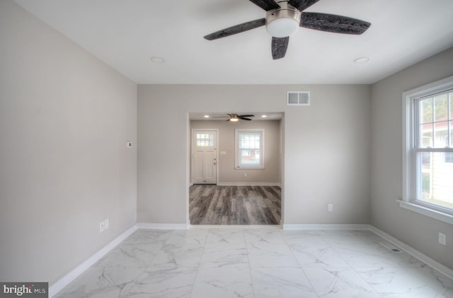 empty room with light wood-type flooring and ceiling fan