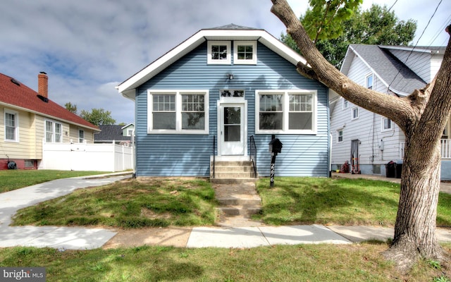 bungalow-style home featuring a front yard