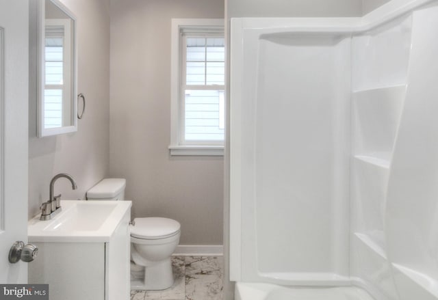 bathroom featuring walk in shower, vanity, and toilet