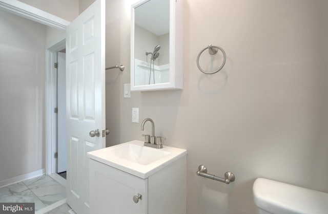 bathroom featuring vanity and toilet