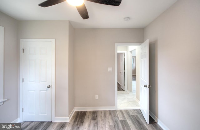 unfurnished bedroom featuring wood-type flooring and ceiling fan