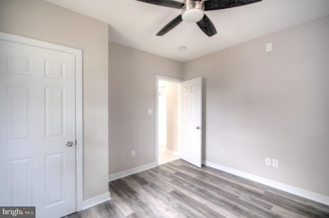 unfurnished bedroom featuring ceiling fan and wood-type flooring