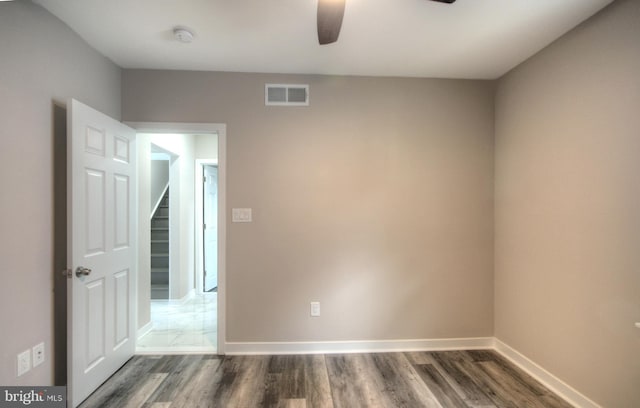 spare room with ceiling fan and dark hardwood / wood-style floors