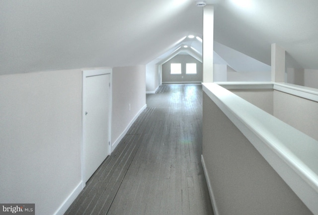 bonus room featuring lofted ceiling and dark hardwood / wood-style floors