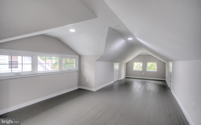 additional living space with lofted ceiling and dark hardwood / wood-style floors