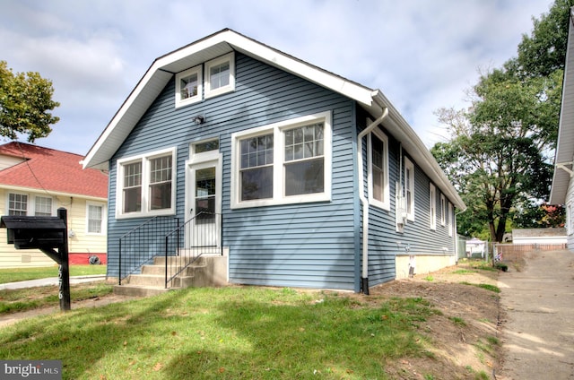 bungalow-style house with a front lawn