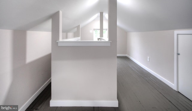 bonus room featuring dark wood-type flooring and vaulted ceiling