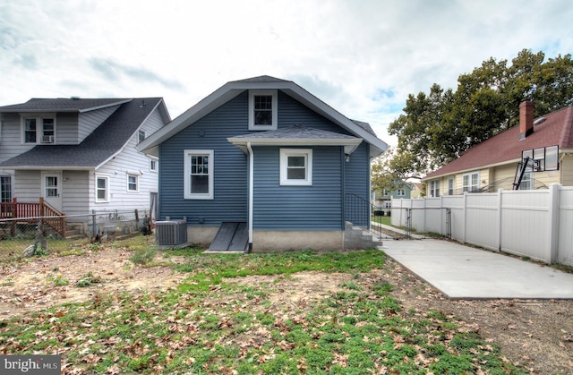 rear view of property with cooling unit