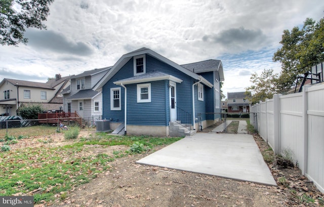 back of house featuring central AC