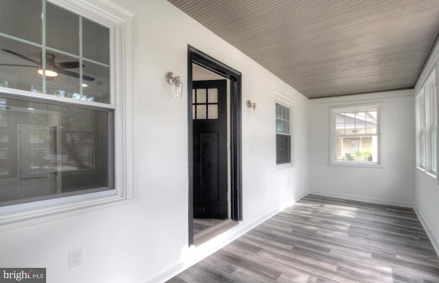 unfurnished sunroom featuring ceiling fan