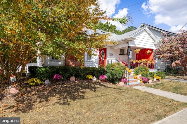 view of front of house with a front yard and covered porch