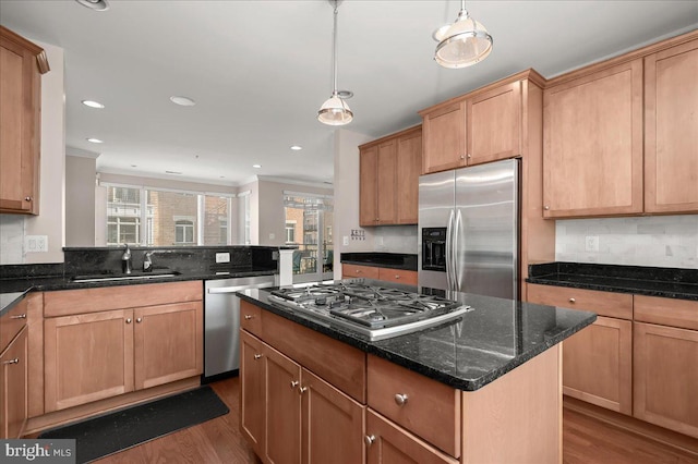 kitchen featuring pendant lighting, dark wood-type flooring, sink, and stainless steel appliances