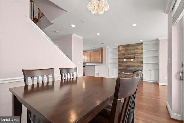 dining room featuring a notable chandelier, crown molding, and hardwood / wood-style floors