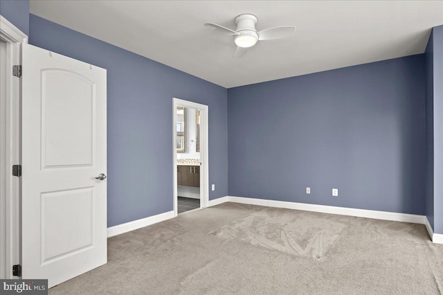 unfurnished bedroom with ensuite bathroom, ceiling fan, and carpet flooring