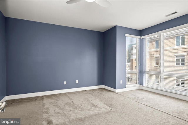 carpeted spare room featuring ceiling fan