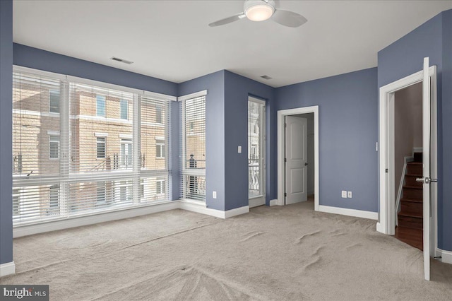 unfurnished bedroom with ceiling fan and light carpet