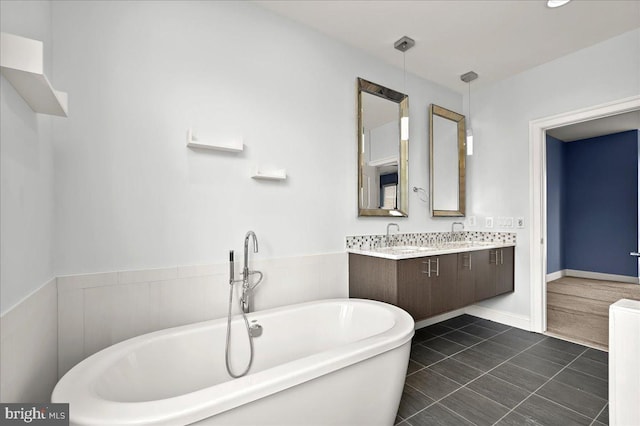 bathroom featuring vanity, a tub to relax in, and tile patterned flooring