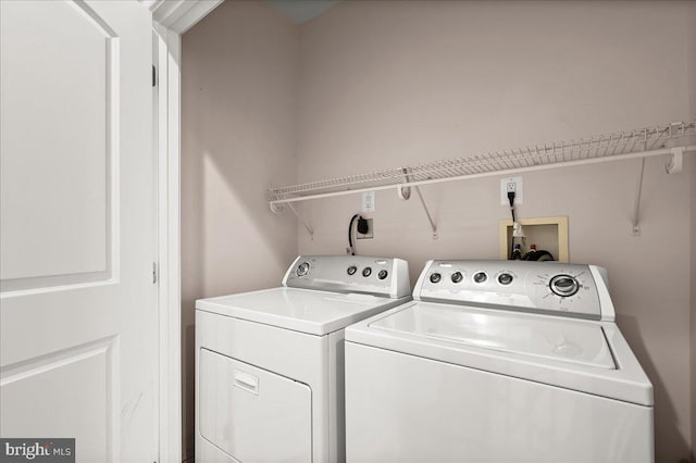 clothes washing area with washing machine and clothes dryer