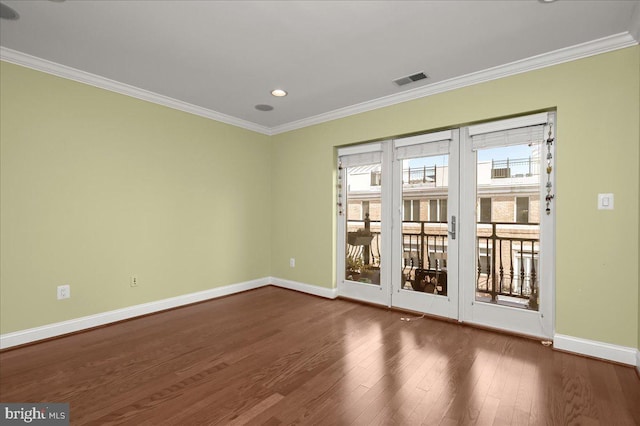 spare room with dark wood-type flooring and ornamental molding