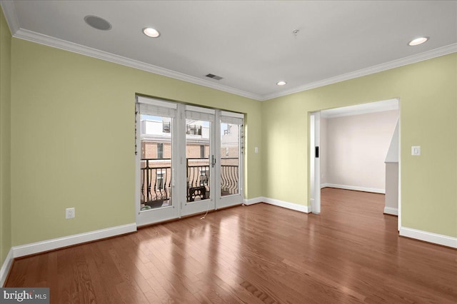 spare room with crown molding and wood-type flooring