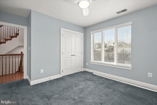 unfurnished bedroom with a closet and dark carpet