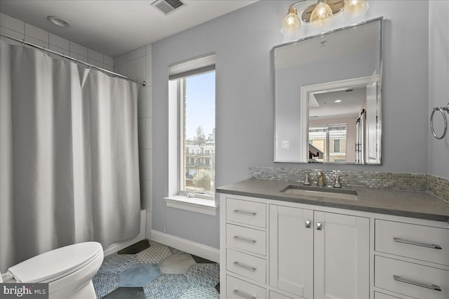 full bathroom featuring vanity, tasteful backsplash, shower / bath combination with curtain, tile patterned floors, and toilet