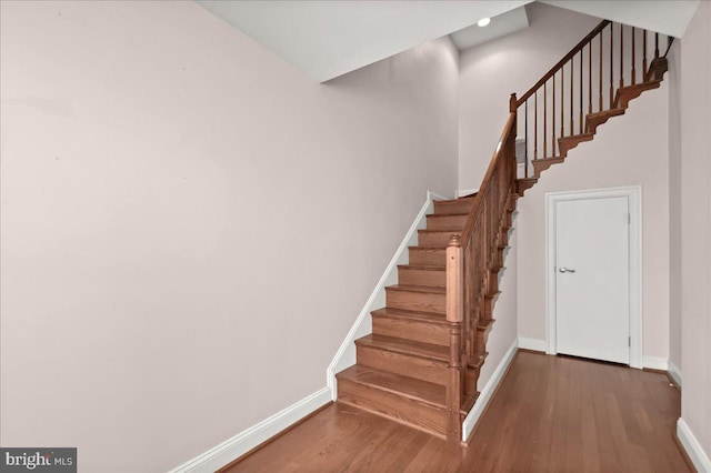 stairs with hardwood / wood-style floors