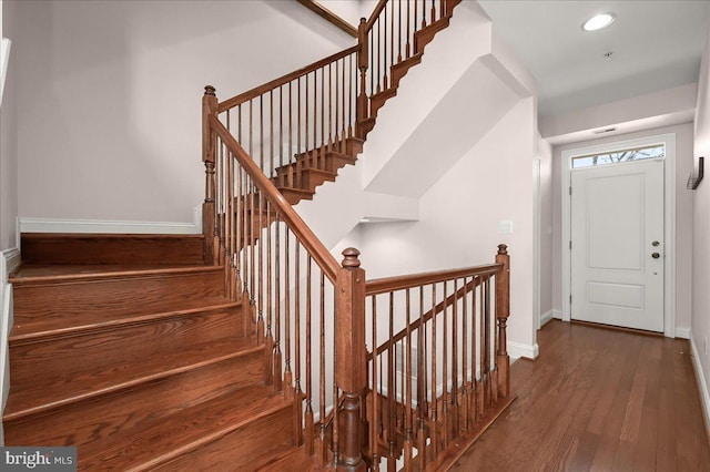 stairs featuring hardwood / wood-style floors