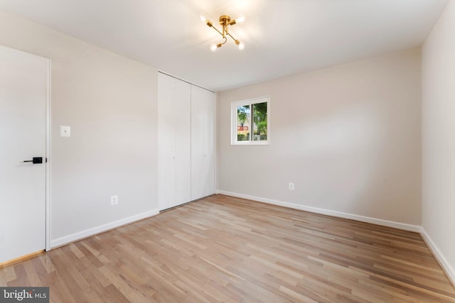 unfurnished room with light wood-type flooring