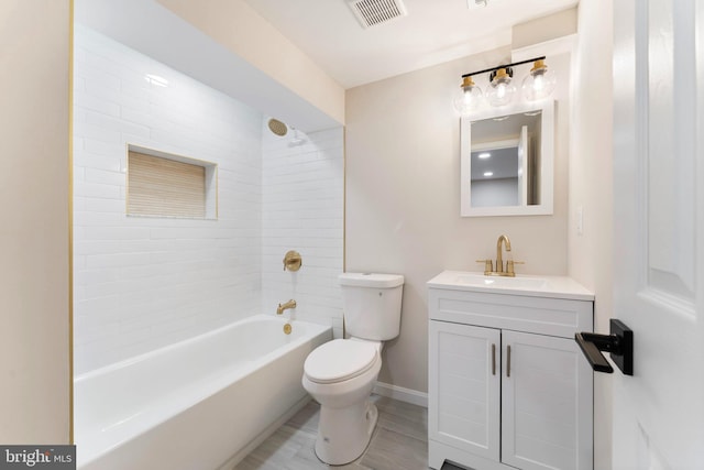 full bathroom with vanity, toilet, and tiled shower / bath