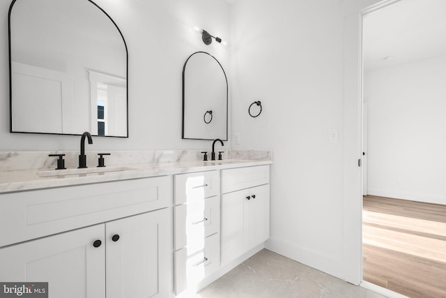 bathroom with vanity and wood-type flooring