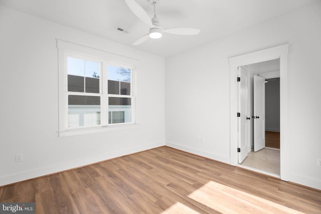 unfurnished room with ceiling fan and hardwood / wood-style flooring