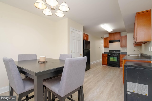 1121 Ward St, Baltimore, MD 21230 - dining room with a chandelier and light wood-type flooring