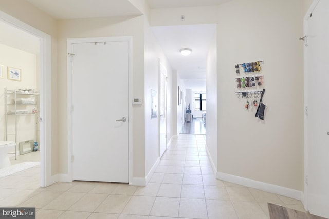 hall featuring light tile patterned floors