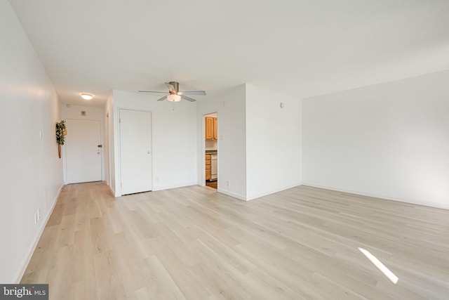 spare room with light hardwood / wood-style flooring and ceiling fan