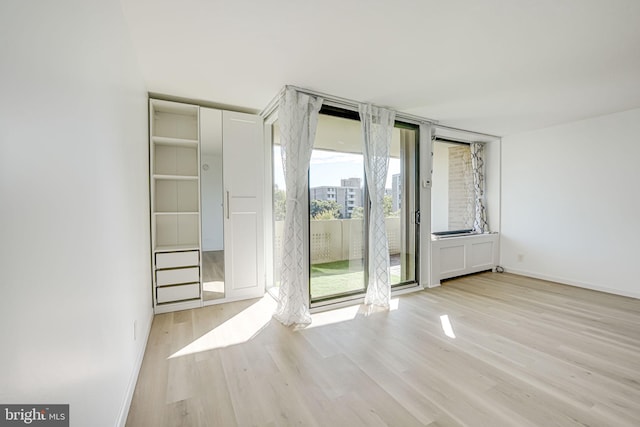 spare room with light wood-type flooring