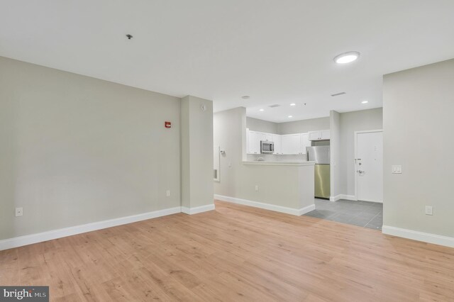 unfurnished living room with light hardwood / wood-style floors