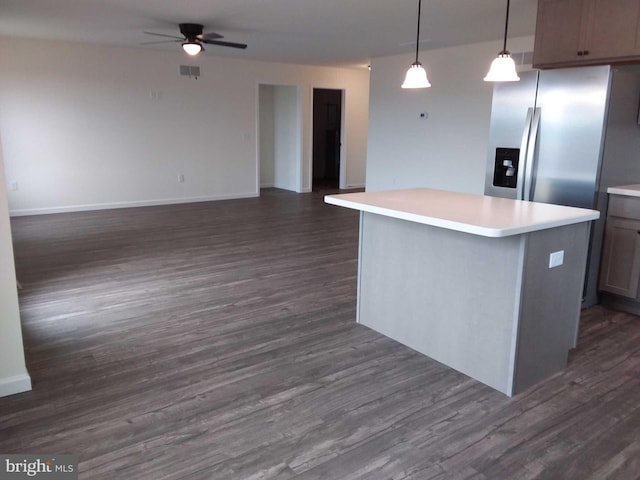 kitchen featuring pendant lighting, a kitchen island, and dark hardwood / wood-style flooring