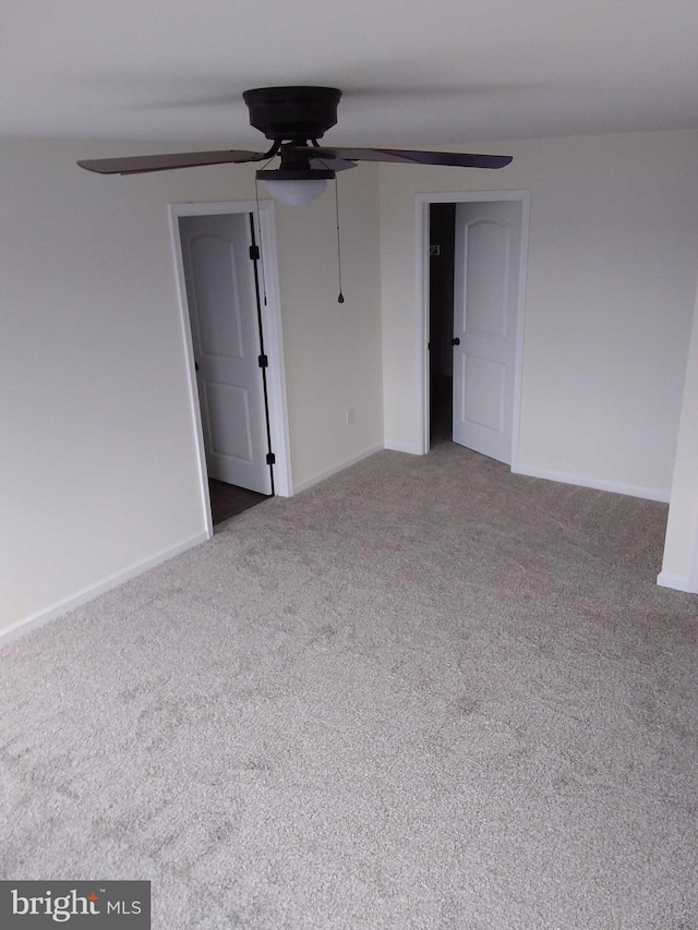 spare room with carpet floors and ceiling fan