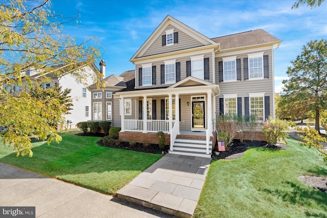 view of front of house with a front yard and covered porch