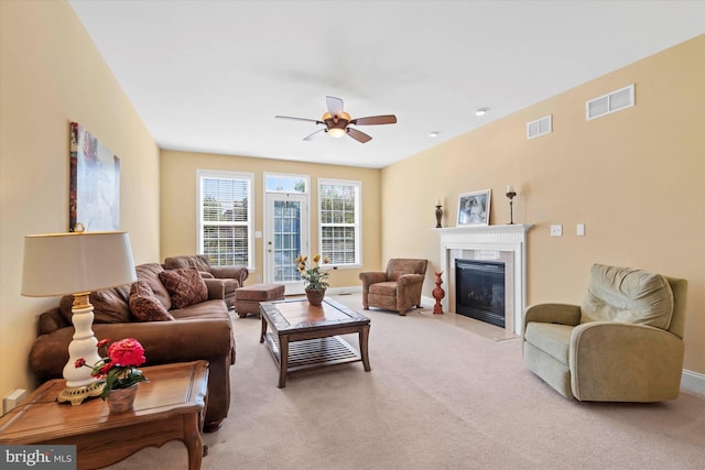 living room with ceiling fan and light carpet