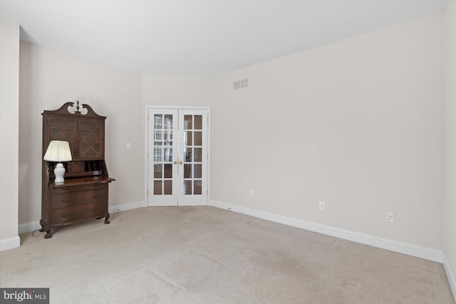 carpeted empty room with french doors